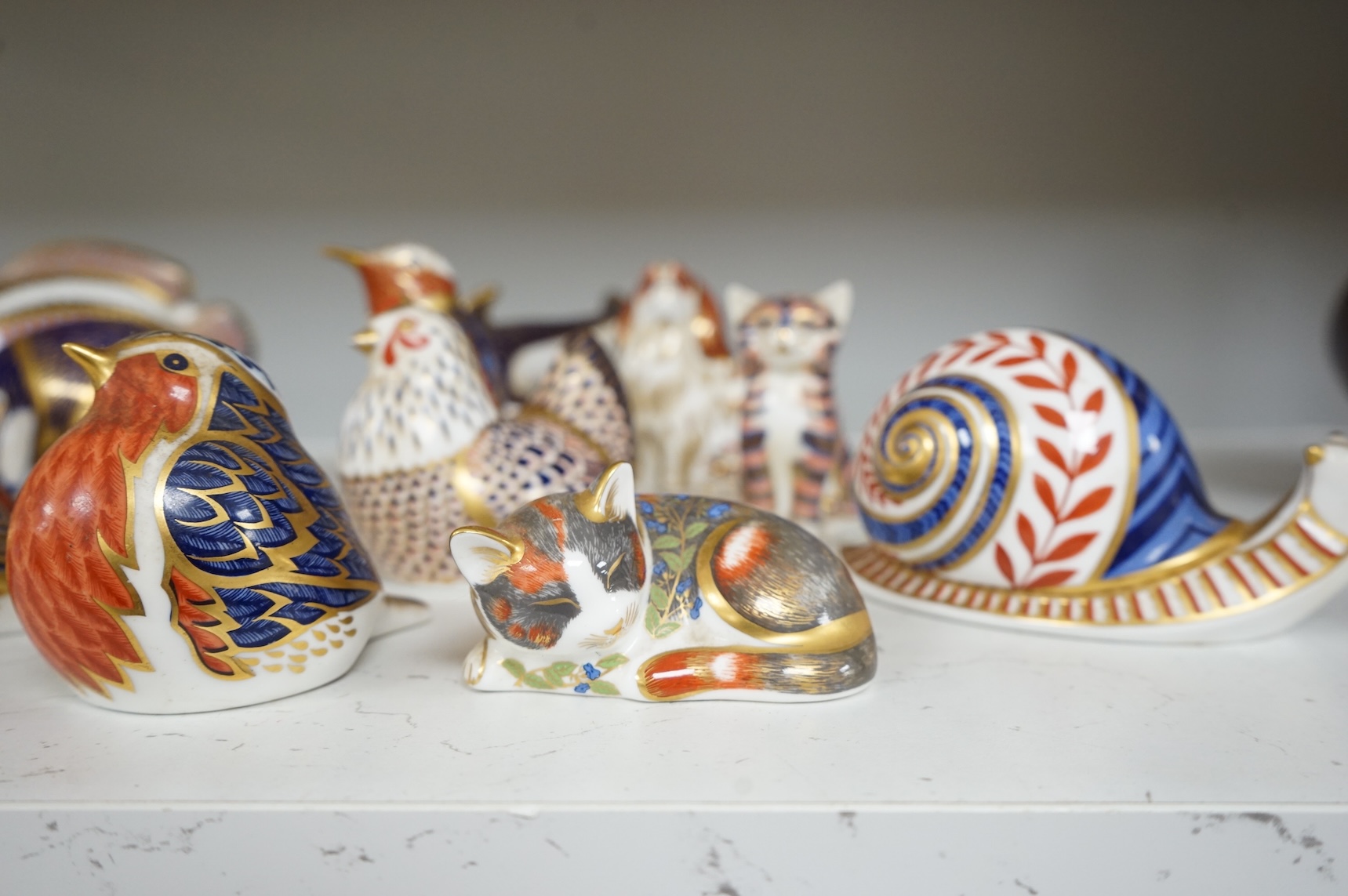 A collection of Royal Crown Derby Imari animal paperweights to include cats, fish and birds, largest 14cm high